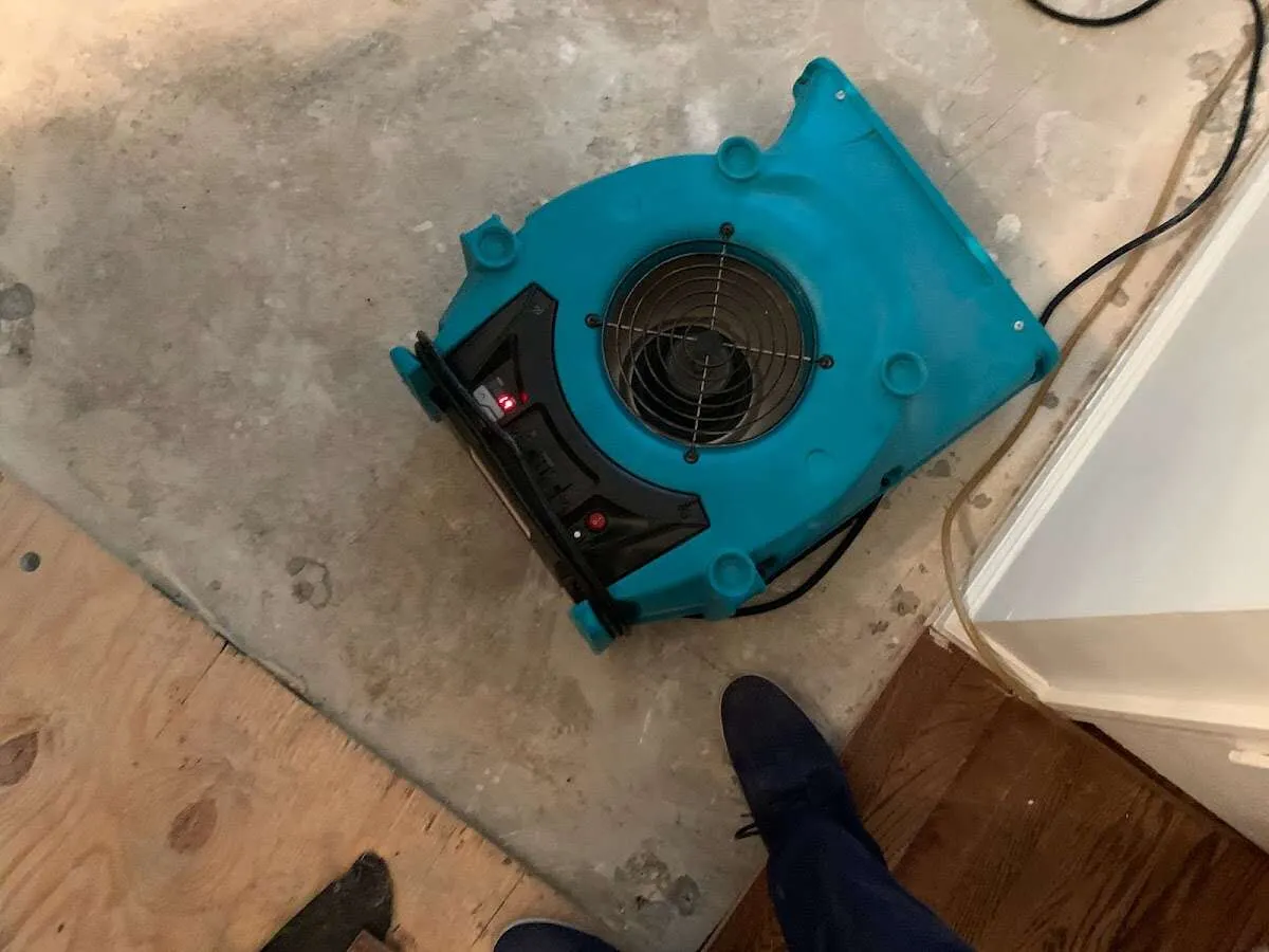 Air mover drying subfloor during Leak Detection & Repair in Vancouver